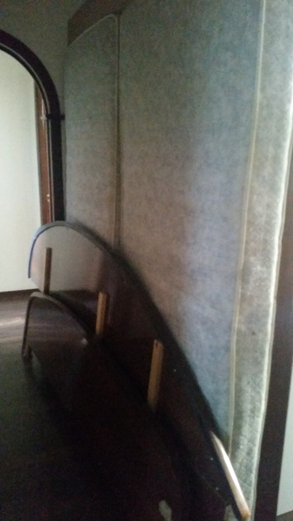 Our old bed waiting for a new home in our hall. Hopefully the landlords will figure out what to do with it...